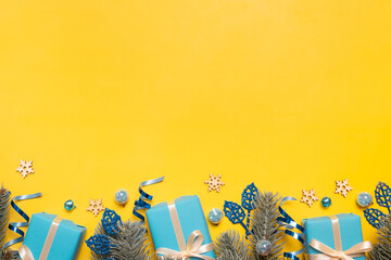Wall Mural - christmas background with pine tree, gifts and festive decorations top view. xmas flat lay. copy spa