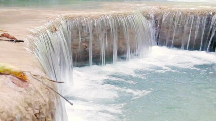 Wall Mural - Jungle landscape with flowing turquoise water of Erawan cascade waterfall at deep tropical rain forest. Erawan National Park, Kanchanaburi, Thailand