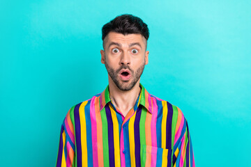 Wall Mural - Photo of impressed excited funny man with brunet hair dressed striped shirt open mouth staring isolated on turquoise color background