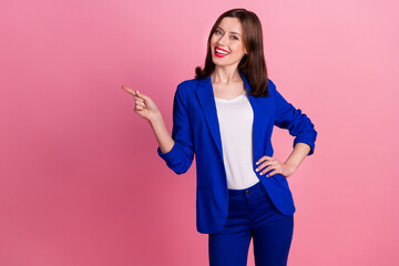 Sticker - Photo of young realtor gorgeous successful business lady wear blue formal costume finger point empty space promo isolated on pink color background