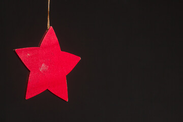 red glitter star shaped christmas decoration isolated on black background