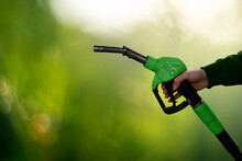 Hand With Fuel Nozzle With Inscription BIO. Carbon Neutral Bio Fuel Decarbonization Concept