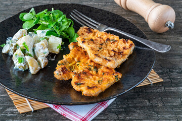 Canvas Print - Lemon and thyme pork schnitzel with potato salad