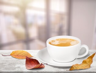 Wall Mural - Cozy composition. Hot coffee cup with foliage.