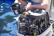 © Irene - Man pouring and refueling engine motor oil into the engine for boat or yacht.