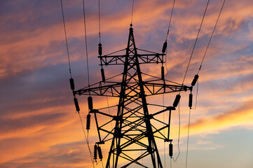 Wall Mural - Electricity pylon (high voltage power line), black contour,  against the background of a romantic evening sky