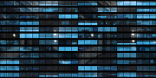 Seamless Skyscraper Facade With Blue Tinted Windows And Blinds At Night. Modern Abstract Office Building Background Texture With Glowing Lights Against Dark Black Exterior Walls. 3D Rendering..