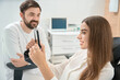 © Viacheslav Yakobchuk - Pleased dental clinic client examining her teeth after treatment