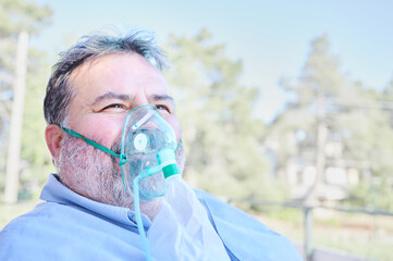 overweight 60 year old male patient recovers from his respiratory disease using a portable oxygen co