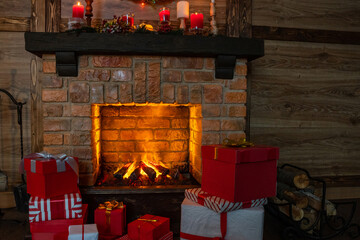 Wall Mural - Many gift boxes near the Christmas fireplace in a festive interior of a Log Cabins with wooden walls. Mantelpiece with candles, Christmas wreath with bells