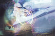 © peshkova - Double exposure of woman's hands on background with technology and digital coding icons. Data development concept. Close up.