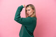© luismolinero - Young caucasian woman isolated on pink background doing strong gesture