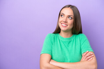 Wall Mural - Young caucasian woman isolated on purple background happy and smiling