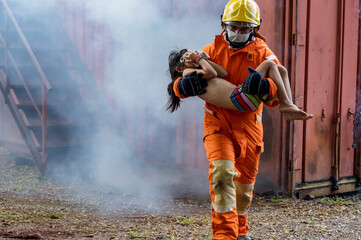 Wall Mural - Firefighter to save girl in fire and smoke. Rescue Team or Firefighters save lives people from fire. Firefighter or Emergency team rescue saving life people from fire