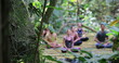 © Marco - People meditating outdoors in nature. Group of friends in meditatin together