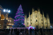 Panorama of the Piazza Duomo square on the New Year and Christmas tree. Albero di Natale with colored lights. City at night. One night ahead. Multi-colored lights. Milan, Italy, December 