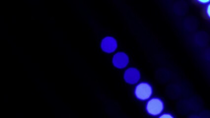Wall Mural - Blue Glowing Defocused Dots Lines Moving Diagonally. 4K Loop abstract straight line dot run on the screen. Defocused dots bokeh of led lights. Blue Falling bokeh dots lines with trail.