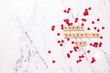 Valentines day postcard. Romantic  layout. Wooden latters on  white marble background.  Top view. Place for text.