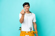 © luismolinero - Young electrician Argentinian man isolated on blue background inviting to come with hand. Happy that you came