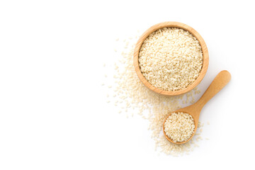 Wall Mural - White sesame seeds in wooden bowl and spoon isolated on white background , top view , flat lay.