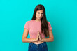 © luismolinero - Young Brazilian woman isolated on blue background keeps palm together. Person asks for something