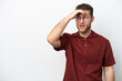 © luismolinero - Young caucasian man isolated on white background doing surprise gesture while looking front