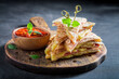 Spicy and hot quesadilla made of tortilla, ham and cheese.