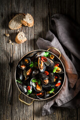 Wall Mural - Tasty and spicy mussels with chili peppers and coriander.