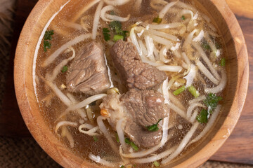Wall Mural - clear stewed pork soup in a wooden bowl