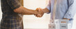 © Pormezz - construction worker and contractor. Client shaking hands with team builder in renovation site.
