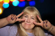 © Светлана Лазаренко - Portrait of a funny middle-aged woman, she shows a victory sign with her fingers.