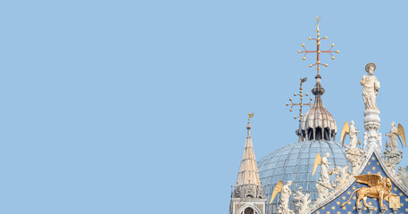 Wall Mural - Panoramic view over decoration elements at roofs and cupolas of Basilica San Marco in Venice, Italy, at sunny day and blue sky solid background with copy space