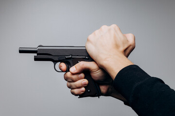 Wall Mural - Close up of man hands with aiming gun on white background.