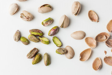 Wall Mural - Close up of peeled pistachio nut seeds isolated on the white background. Salted dried beer snack. Macro shot