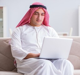 Wall Mural - Arab businessman working sitting at couch