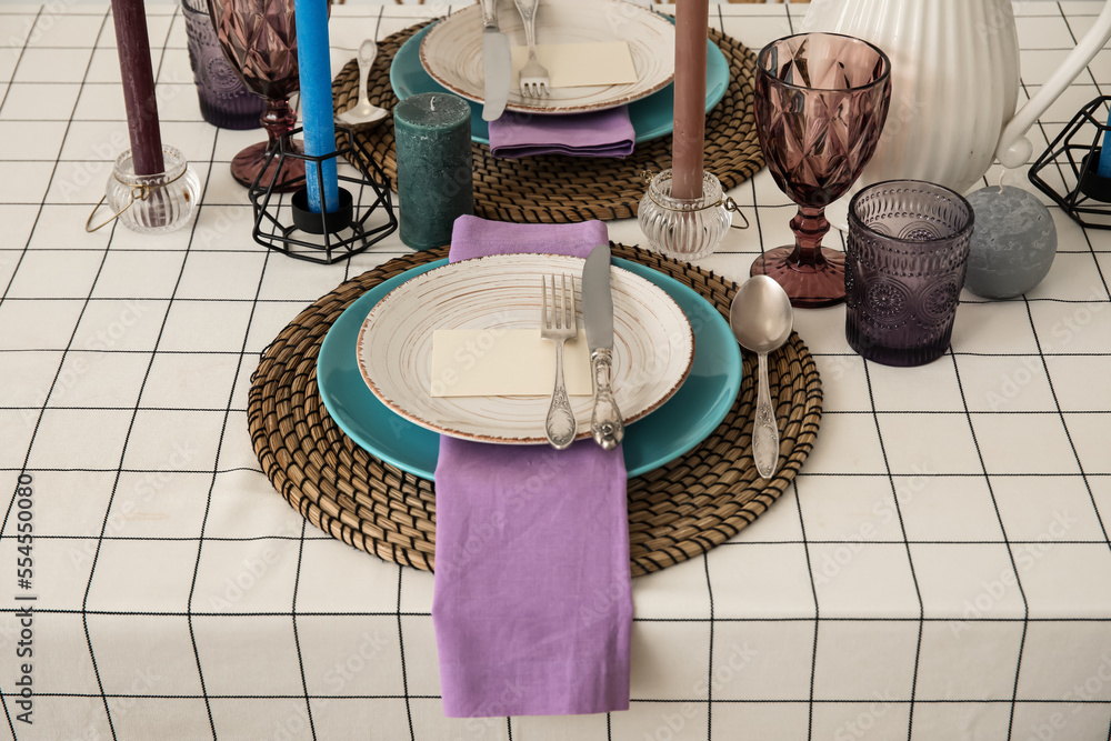 Beautiful table setting with candles and blank card, closeup