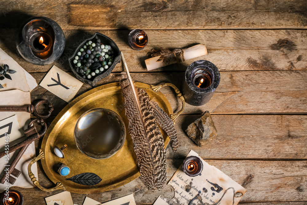 Magic attributes of soothsayer on wooden table, top view