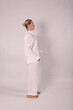 © Шамиль Алиев - Young girl in white house clothes on a white background in the studio