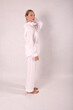 © Шамиль Алиев - Young girl in white house clothes on a white background in the studio