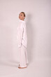 © Шамиль Алиев - Young girl in white house clothes on a white background in the studio