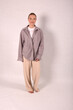 © Шамиль Алиев - A young girl in beige home clothes on a white background in the studio