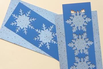 Wall Mural - blue paper stencils with snowflake cutouts on holiday cards