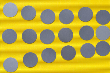 Poster - set of gray paper circles on textured yellow paper