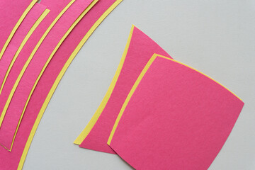 Poster - pink and yellow paper stripes (mostly) on blank paper