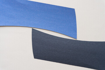 Wall Mural - blue and black construction paper shapes on a plain background