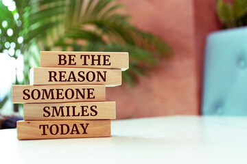 Wall Mural - Wooden blocks with words 'Be The Reason Someone Smiles Today'.