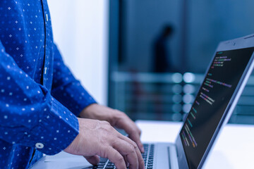programmer coding, compiler, encode, debug, and developer application software for business corporate with laptop computer. Man programming coding web app from work at home, code show screen monitor