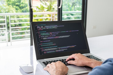 programmer coding, compiler, encode, debug, and developer application software for business corporate with laptop computer. Man programming coding web app from work at home, code show screen monitor