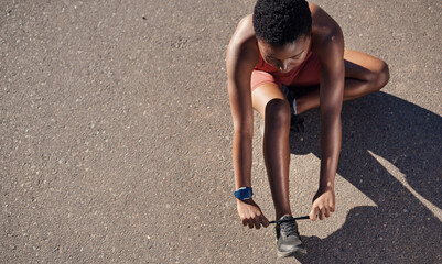 Wall Mural - Black woman, fitness and shoes in preparation for running, exercise or cardio workout on mockup. African American woman runner tying shoe lace getting ready for race, run or sports above on mock up