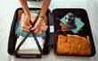 © Kay A/peopleimages.com - Travel suitcase, bedroom and hands of woman packing for Europe holiday, vacation or adventure tourist journey. Hospitality, hotel bed and photographer with luggage bag, clothes and camera in Madrid